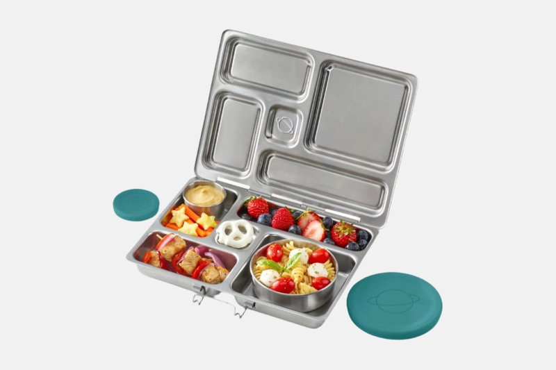 PlanetBox Rover stainless steel lunch box open, with five compartments of food and two small silicone dipper lids