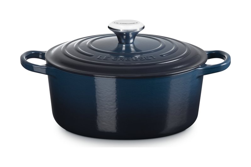 Le Creuset Signature round cast iron casserole in navy with its lid and stainless knob